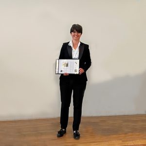 Francesca Torriani, Chair of the ESA’s Flange Gaskets Division, holding a plaque.