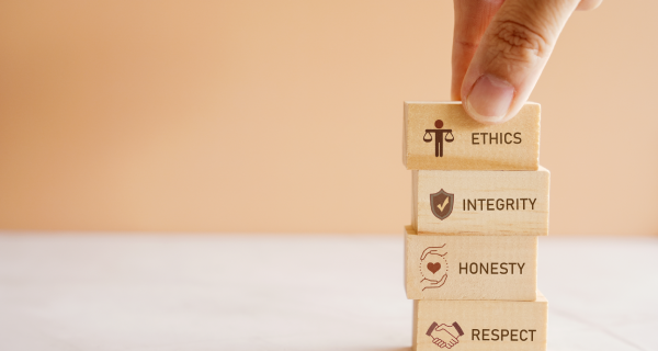 Hand holding wooden block with code of conduct concept, ethics, integrity, honesty, respect.